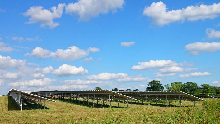 Summer day solar farm near Cambridge after cleaning working at full capacity