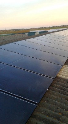Multiple solar panels installed over a warehouse near Cambridge