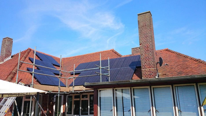 Work in progress solar panels installation over a very large house near Cambridge