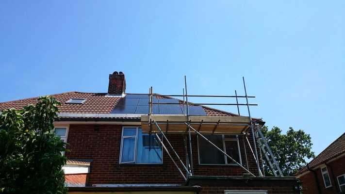 Work in progress tidy installation of solar panels over a semi-detached house near Cambridge