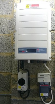 Solar panels inverter installed on a wall of a detached house in Cambridge
