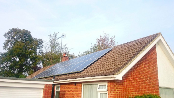 Two rows of solar panels installed on a sunny summer day on a detached house near Cambridge