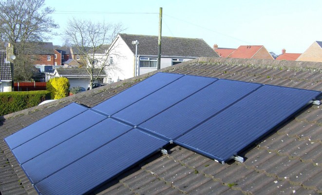 Cambridge neighbourhood and eight solar panels producing electricity