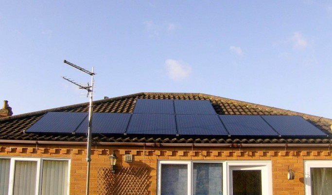Eight solar panels over a bungalow house near Cambridge producing energy