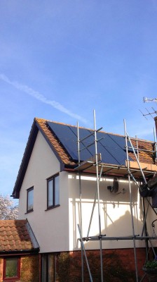 Solar panels being installed on a large family house near Cambridge